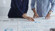© rogerphoto - Professional business team analyzing financial reports, sharing insights and planning strategic decisions in modern workplace setting
