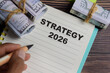 © syahrir - Concept of strategy 2026 write on book with keywords isolated on Wooden Table.
