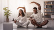 © Prostock-studio - Happy African American Couple Doing Side Bend Stretch Exercise, Working Out Together In Living Room At Home, Using Pc, Sitting On Floor Yoga Mat Looking At Screen. Fitness Workout, Domestic Training