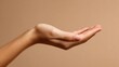 © Johannes - beautiful woman hand isolated on brown background empty open female hand on cream background with copy space close up of elegant palm faced upwards with space for your product no logos no brands ar 1