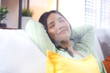 © NT_studio - Happy young asian woman relax and leisure sitting on sofa in living room at home, happiness girl sleeping with calm on couch, woman napping and rest with cozy, one person, lifestyle concept.