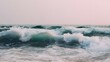 © irawan - Powerful ocean waves crash with white foam under a soft sky.
