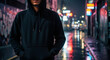 © Nadim Graphic Art - Mysterious figure in a hoodie stands on a wet street at night with neon lights reflecting on the pavement, embodying urban anonymity and intrigue