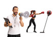 © Ljupco Smokovski - Woman practicing box and coach using a megaphone