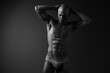 © SHOTPRIME STUDIO - Black and white image of a muscular man posing confidently, showcasing his toned physique and strength, capturing the essence of fitness and determination.
