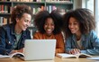 © Riley - Group of multiracial happy teenage students using laptop, working on university assignment homework project in college library. Meeting of diverse young people looking information on computer. High