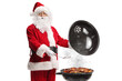© Ljupco Smokovski - Santa claus grilling meat on a barbecue