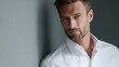 © Chandlerlikes - Elegant male teacher with blue eyes and white shirt, confident expression, standing indoors, masculinity and professionalism concept