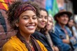 © SerPak - A joyful group of young friends poses together in front of a vibrant mural, showcasing diversity and friendship in an urban setting.