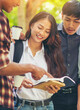 © prachid - Group of Diversity Student reading book and working together,studying for an exam at university.,Happy multi ethnic friend successfully completes the thesis report in asian college-vertical image.