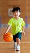 © Liana - Children Joyfully Running on a Gym Court With a Boy Leading the Group While Holding a Basketball