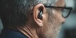 © inspiretta - Man wearing glasses and a black earbud