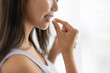 © hidez - Close-up of a Woman Holding a Supplement Pill and a Glass of Water