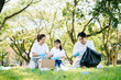© Nuttapong punna - Joyful family volunteering to clean a park together. A heartwarming outdoor scene promoting teamwork, love, and environmental awareness in a green lifestyle.