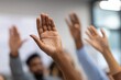 © oksa_studio - Diverse group of audience members raising hands, actively participating, asking questions, and volunteering in a conference or classroom setting