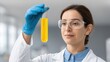 © 69 - Professional Scientist Analyzing Yellow Solution in Test Tube Under Laboratory Conditions with Focus on Research and Experimentation