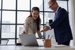 © David - Team of multiethnic professionals sharing conversation in office. Happy business team laughing and engaging in a casual discussion. Group of business people in meeting talking on business report.