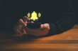 © ParinPIX - Close-up of hands holding a smartphone with glowing notification bell icon above the screen. Concept for mobile alert, app notification, message reminder, and digital communication signal.