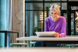 © Westend61 - Professional portrait of smiling woman with tablet in modern office