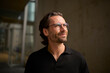 © Westend61 - Portrait of a confident man with glasses in modern urban setting