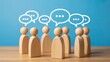 © Kage Dojo - A group of wooden figurines surrounded by speech bubbles, symbolizing communication and conversation.