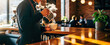 © Victoria - Barista pouring coffee into cup while standing at cafe counter