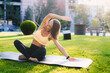 © Strelciuc - A Young Woman Practicing Yoga Peacefully in a Beautiful Park During a Glorious Sunset