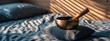 © JovialFox - An inviting scene featuring a singing bowl placed on a bed, prepared for a sound healing session with gentle morning light.