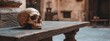 © Anastasija - Skull displayed on a rustic wooden table in an old stone structure in historical museum. Close up view.