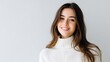© Matcha_09 - Smiling Young Woman in Cozy Sweater Posing Against a Minimalist Background with a Bright and Friendly Expression