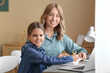 © Pixel-Shot - Female tutor giving lesson to little girl at home