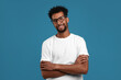 © New Africa - Portrait of happy man on light blue background