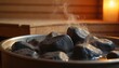 © Pete - Steaming hot sauna rocks. Photo of sauna rocks in a metal bowl creating steam. Sauna interior background is wood and candle light. Wellness scene