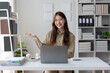 © Wasan - Young Asian businesswoman working with laptop in office.