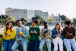 © Xavier Lorenzo - Young group of multiracial people using mobile phone at city street in Barcelona. Youth and social media concept