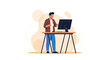 © Jajang - A man in front of a computer, working from a standing desk with a cup in hand