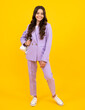© Olena - Full length photo of pretty teenager child girl wear casual clothes isolated on yellow background. Happy teenager, positive and smiling emotions of teen girl.
