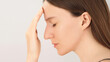 © Pavel - Side view of a young woman with closed eyes, showing signs of stress and discomfort. Concept of headache, fatigue, mental pressure or emotional tension. Copy space