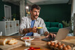 © Miljan Živković - Man working from home having coffee and breakfast