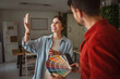 © Miljan Živković - Woman choosing paint color with interior designer holding color palette