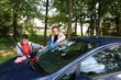 © Vasyl - Woman and boy clean car window using spray bottle and cloth.
