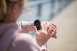 © Dexon Dee - Woman checking smartwatch during outdoor fitness workout