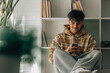 © carballo - teenager at home with cell phone sitting on the floor