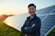 © Maryna - Smiling Asian male solar energy technician stands proudly before solar panels in green field at sunset. Represents renewable energy solutions, clean power generation, technological innovation in