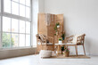 © Pixel-Shot - Interior of light room with wicker armchairs, wooden folding screen and plants