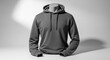 © ADD PHOTO - Gray hoodie sweatshirt displayed on headless mannequin, featuring long sleeves, drawstring hood, and casual style, perfect for relaxed or urban fashion looks