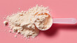 © Ekaterina Kondratova - Scoop of white protein powder is on a pink surface, top view