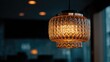 © Ima - Ornate amber pendant lamp in a dimly lit room.