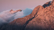 © Travel 'n' Lifestyle - View of rugged mountain peaks emerge through a sea of clouds, kissed by the warm hues of the setting sun, creating a serene spectacle, Carrara, Tuscany, Italy.