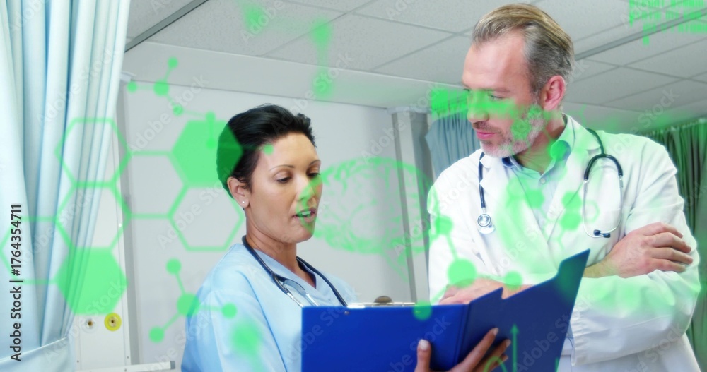 Reviewing medical team examining data in hospital exam room, with ...